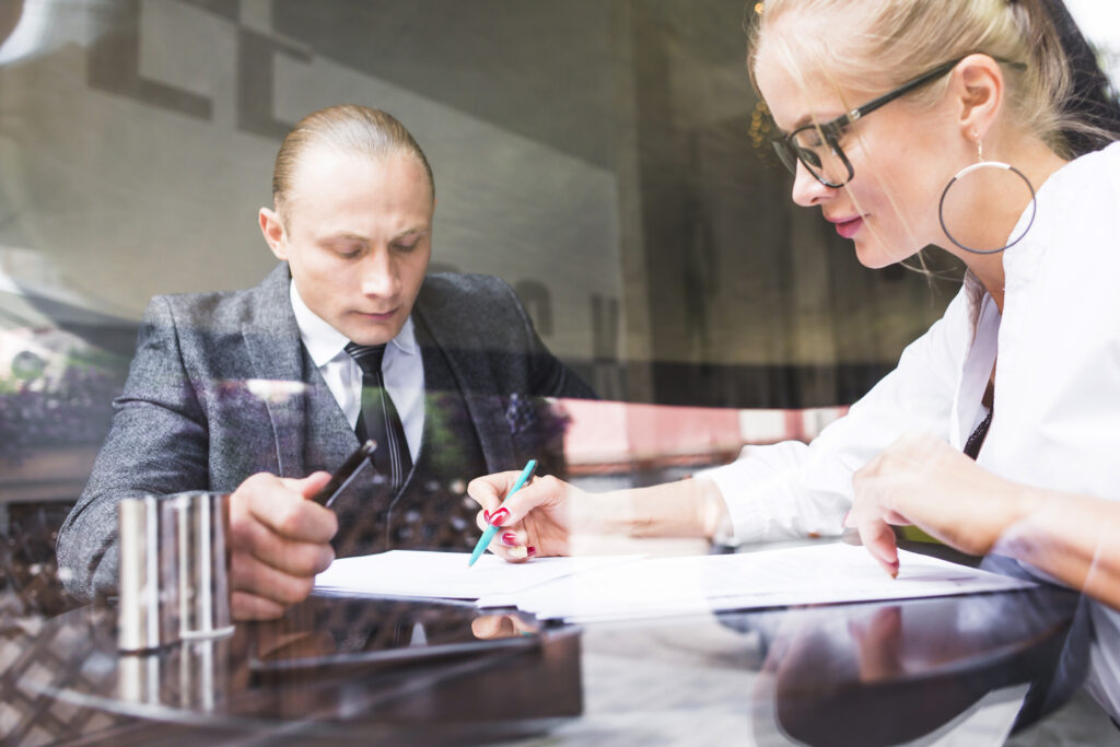 two-businesspeople-examining-document-restaurant